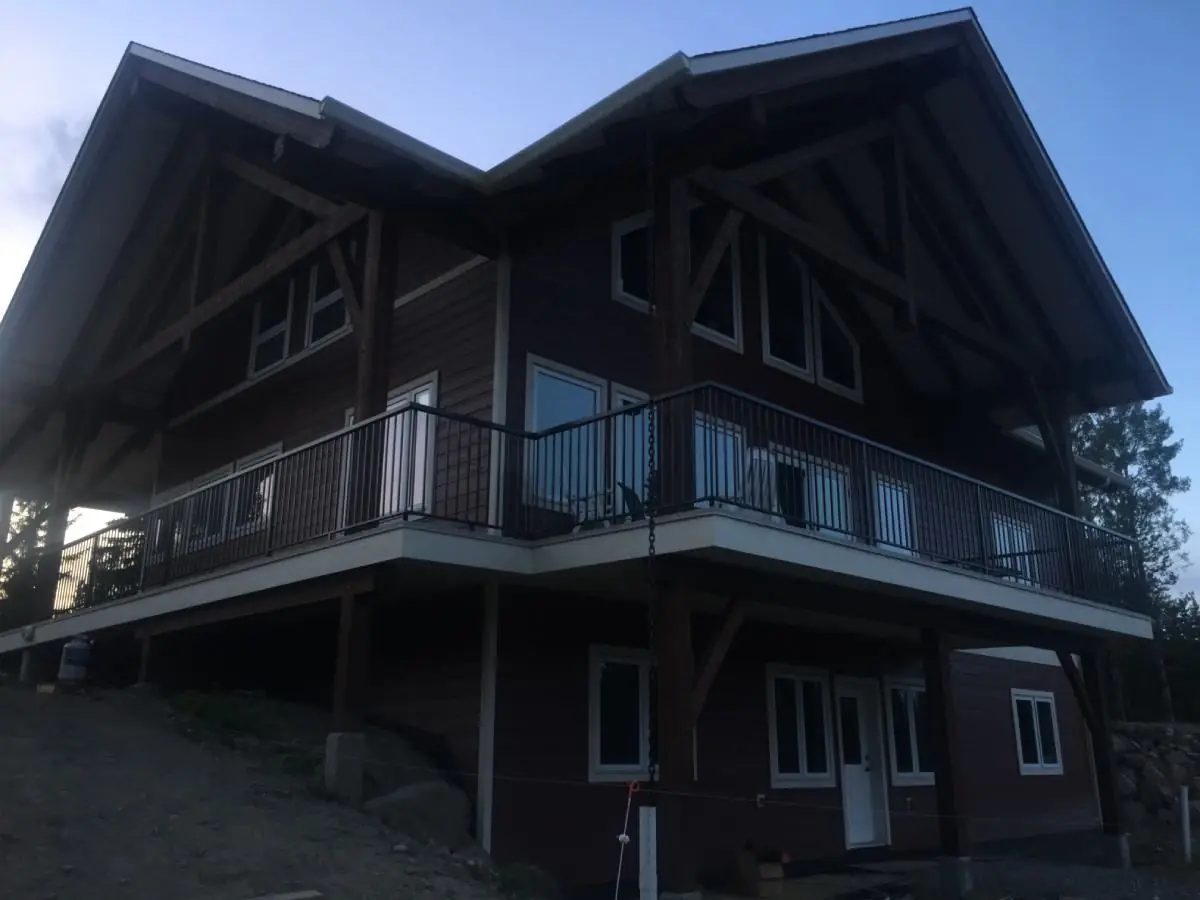 Dark timber-framed home in the Cariboo with new exterior finishes