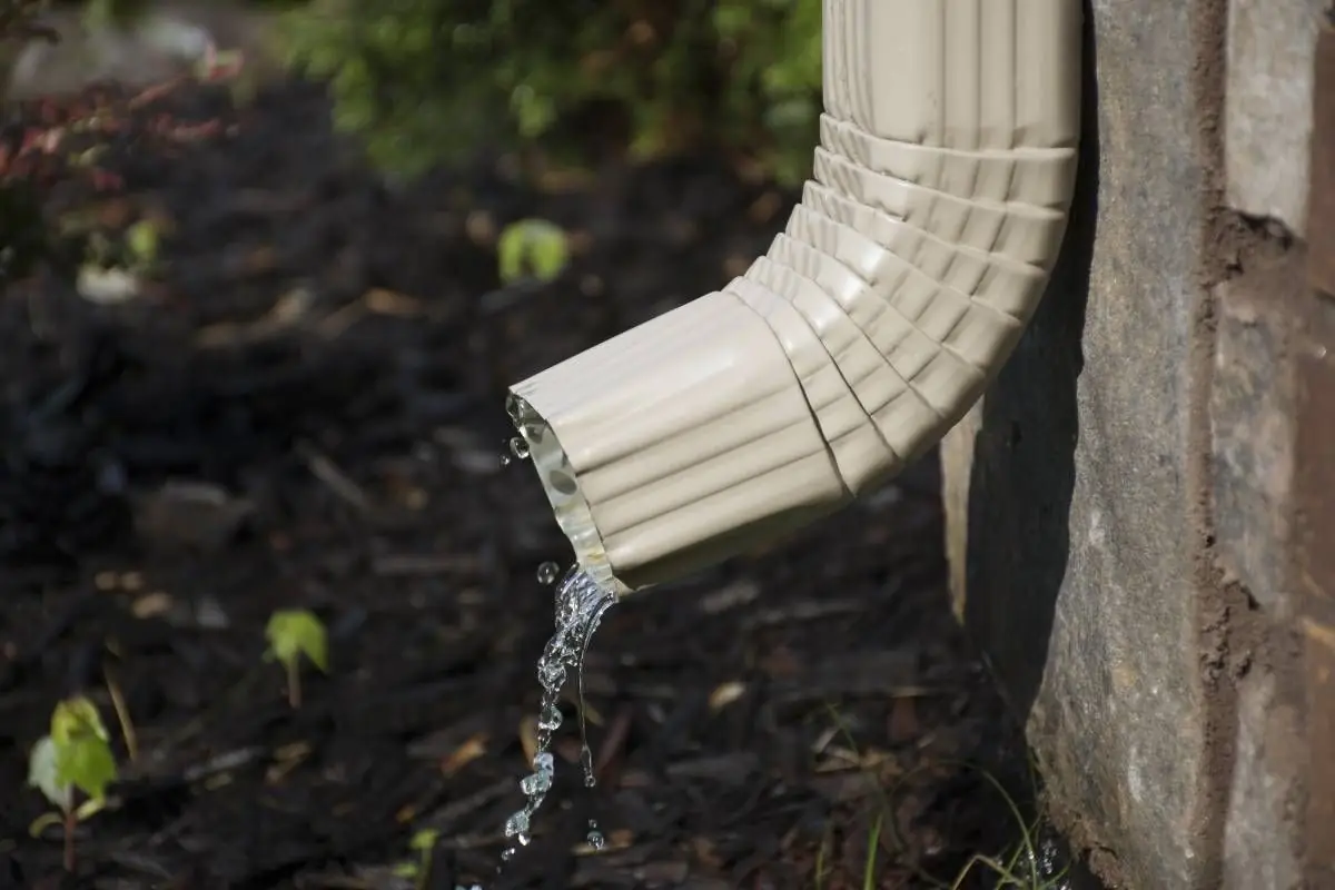 Aluminum downspout draining away from a home's foundation
