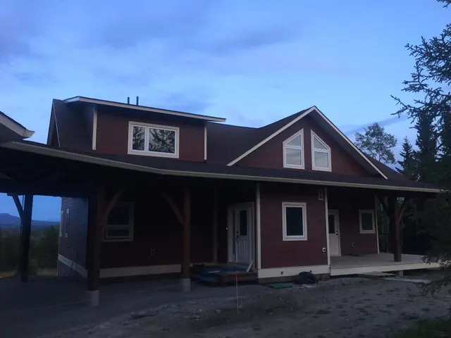 Red craftsman-style home in the Cariboo with finished gutters, fascia and siding along the roofline
