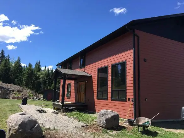 Red home with new gutters and downspouts