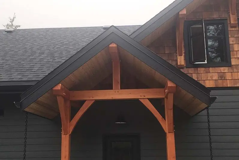 Timber-frame entry with cedar shakes and cleanly finished fascia