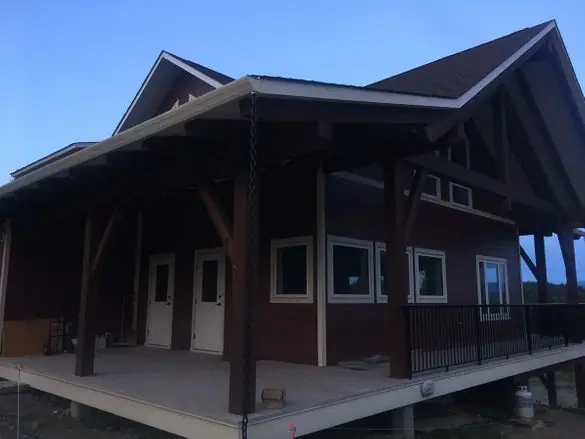 Covered timber porch with a rain chain downspout