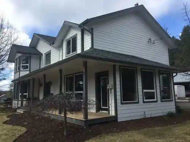 White farmhouse in Williams Lake with new white gutters, soffit and fascia